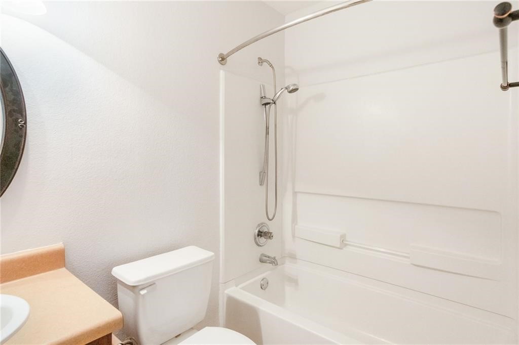 913 Cindy Lane Leander, TX 78641 - Photo 22 of 28 a bathroom with a toilet and a bathtub
