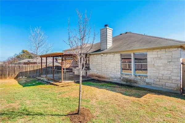 a view of a house with a backyard and a patio