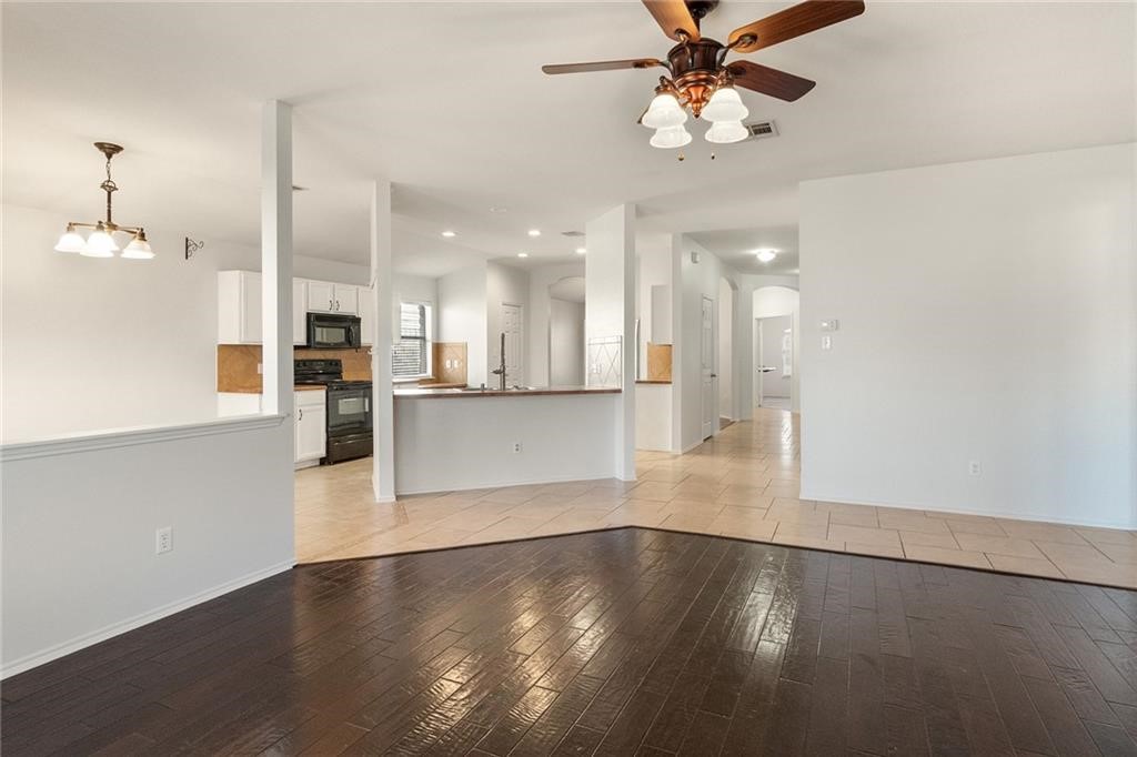 913 Cindy Lane Leander, TX 78641 - Photo 9 of 28 a view of a kitchen with wooden floor and a kitchen