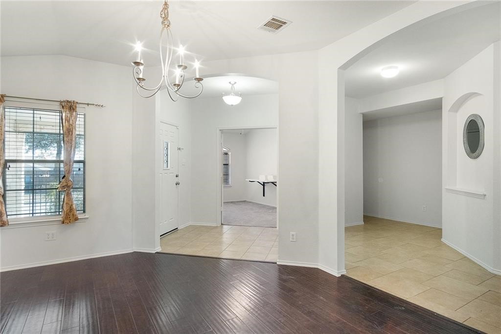 913 Cindy Lane Leander, TX 78641 - Photo 10 of 28 wooden floor in an empty room with a window