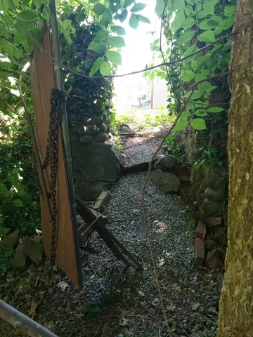 a view of a chair and tables in the backyard of a house