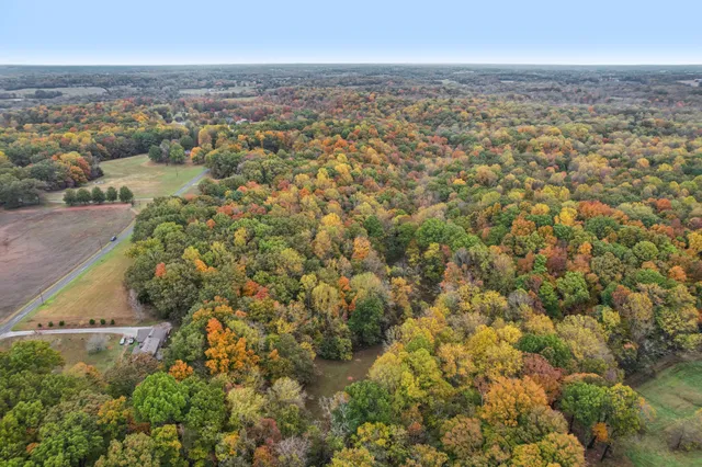 an aerial view of residential building with green space