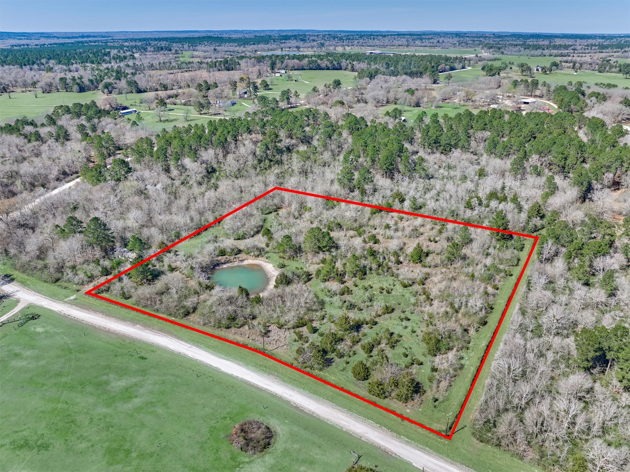 0 Piney Point Road Huntsville, TX 77340 - Photo 5 of 9 a view of a yard with a wooden fence
