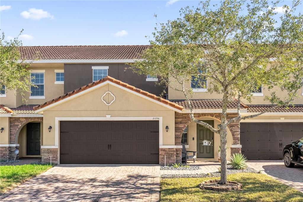 2096 Water Tupelo Way Ocoee, FL 34761 - Photo 1 of 32 a front view of a house with garden