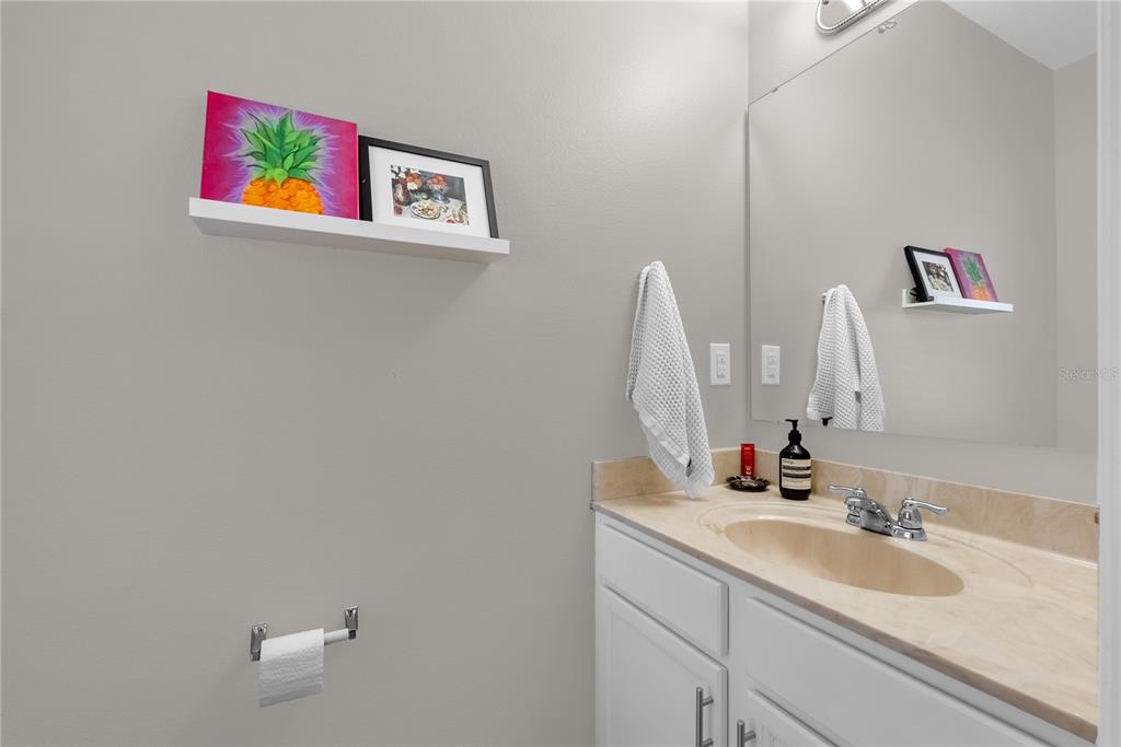 2096 Water Tupelo Way Ocoee, FL 34761 - Photo 14 of 32 a bathroom with a sink and a mirror