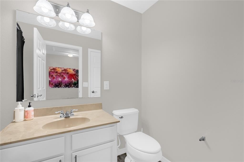 2096 Water Tupelo Way Ocoee, FL 34761 - Photo 24 of 32 a bathroom with a sink vanity mirror and toilet