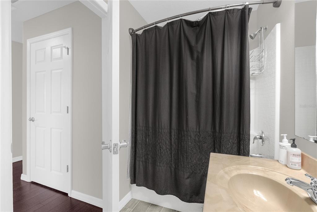 2096 Water Tupelo Way Ocoee, FL 34761 - Photo 25 of 32 a bathroom with a sink and a mirror