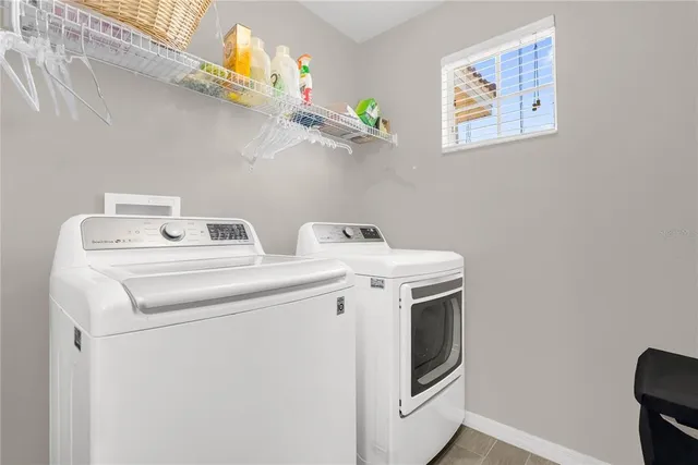 a view of a patio with table and chairs under an umbrella