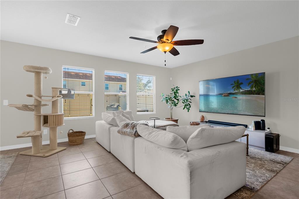 2096 Water Tupelo Way Ocoee, FL 34761 - Photo 3 of 32 a living room with furniture and a flat screen tv