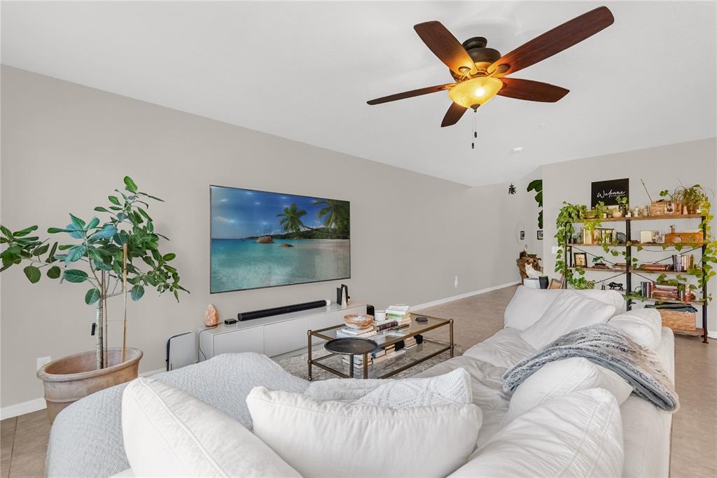 2096 Water Tupelo Way Ocoee, FL 34761 - Photo 5 of 32 a living room with furniture and a potted plant