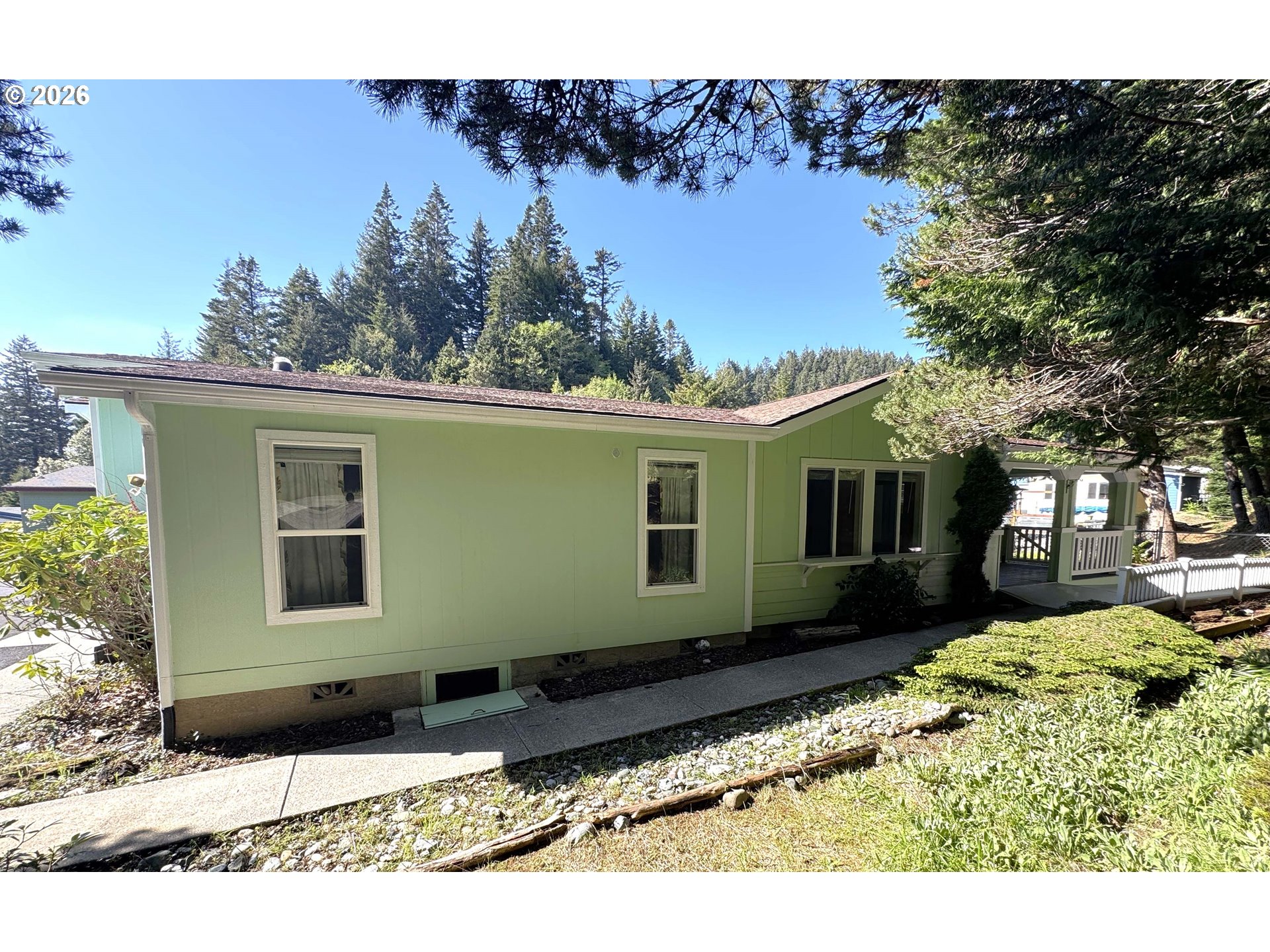94355 11th Street Gold Beach, OR 97444 - Photo 2 of 41 a view of a house with a backyard