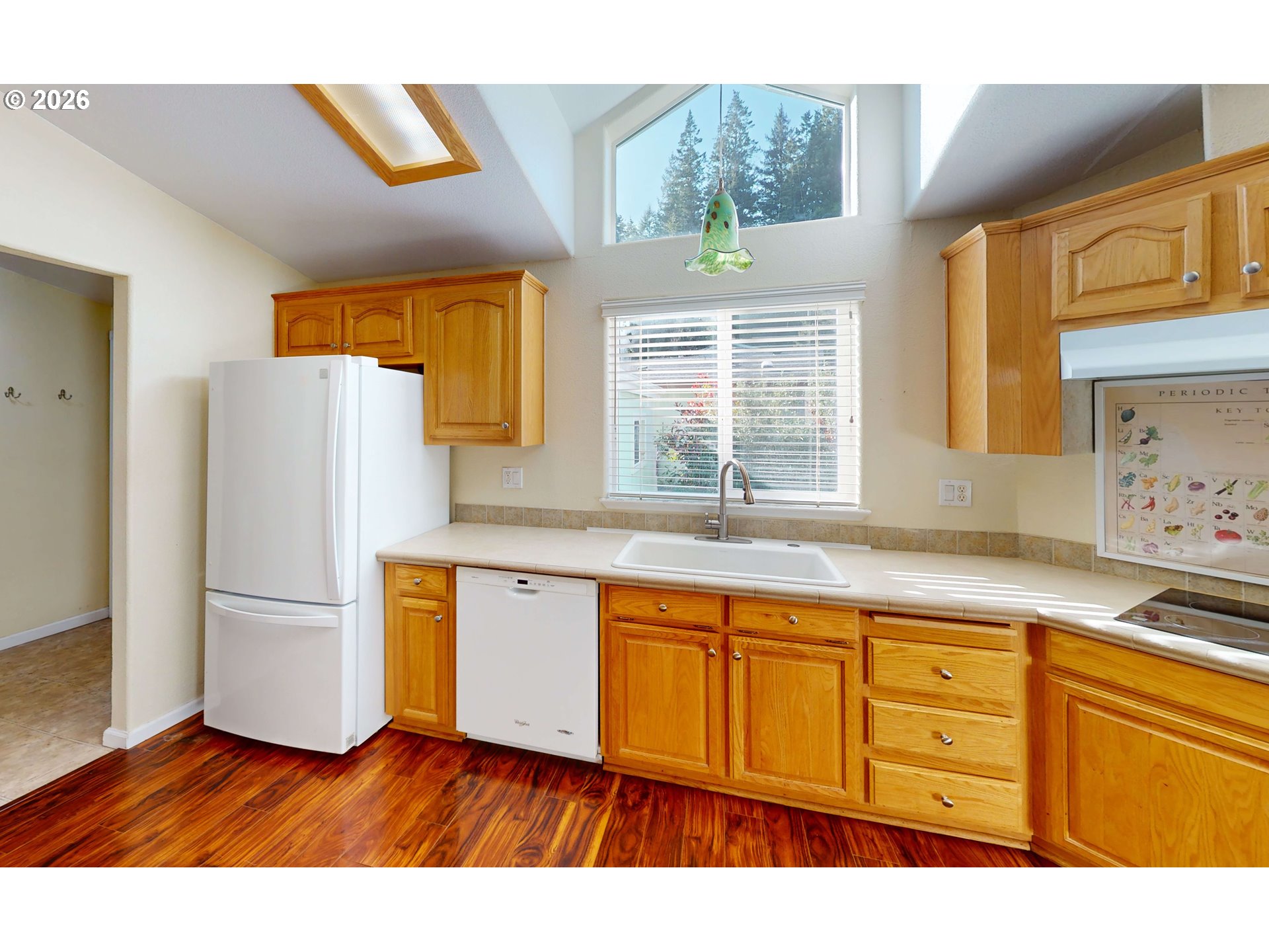 94355 11th Street Gold Beach, OR 97444 - Photo 5 of 41 a kitchen with granite countertop wooden floors and stainless steel appliances