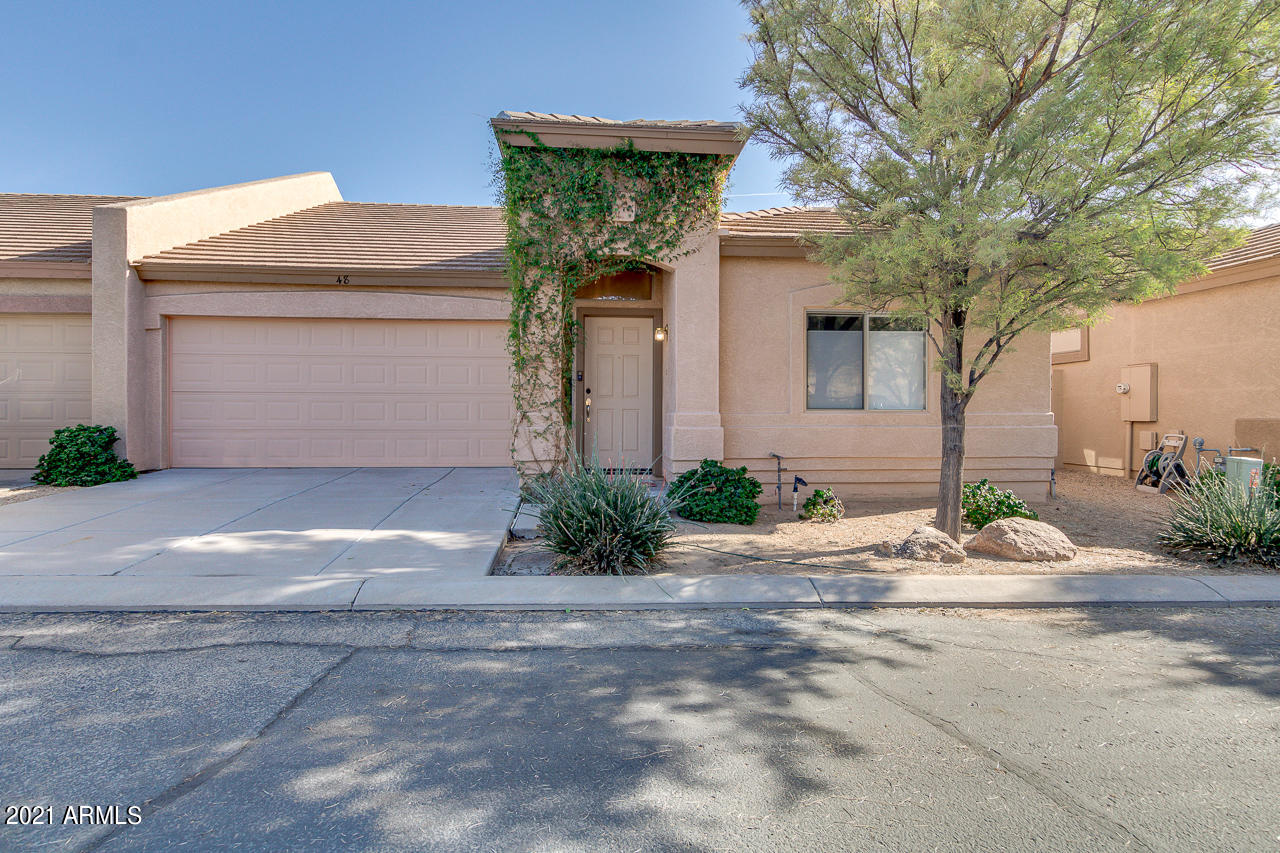 44 South Greenfield Road, Unit 48 Mesa, AZ 85206 - Photo 1 of 32 a front view of a house with a yard and garage