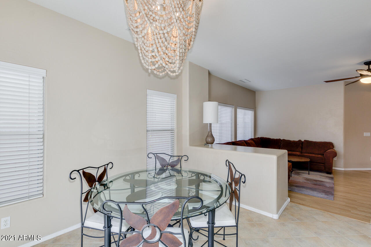 44 South Greenfield Road, Unit 48 Mesa, AZ 85206 - Photo 11 of 32 a view of a dining room with furniture and chandelier