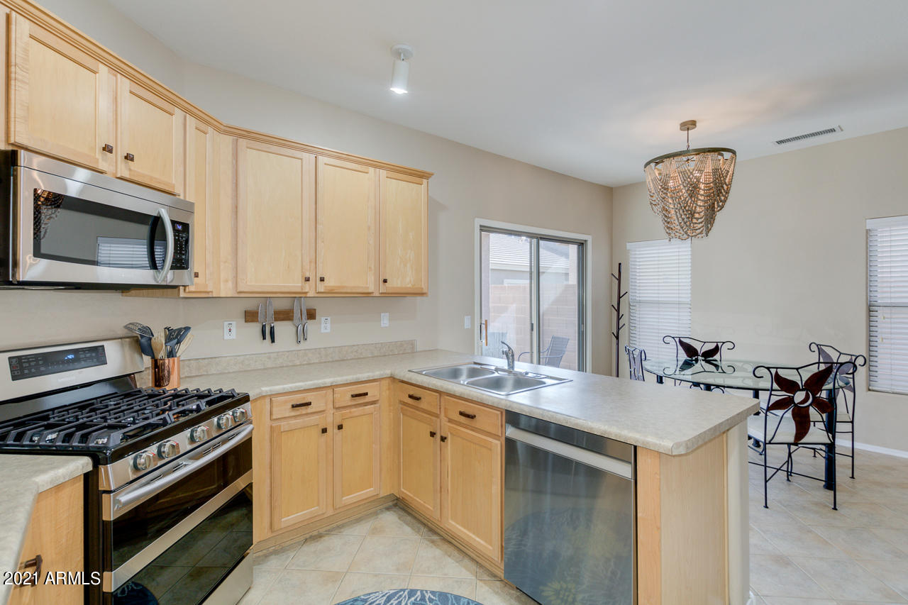 44 South Greenfield Road, Unit 48 Mesa, AZ 85206 - Photo 15 of 32 a kitchen with a sink stove and microwave