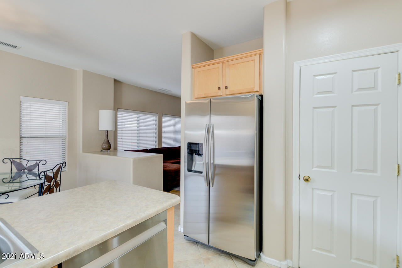 44 South Greenfield Road, Unit 48 Mesa, AZ 85206 - Photo 17 of 32 a kitchen with a refrigerator and a sink