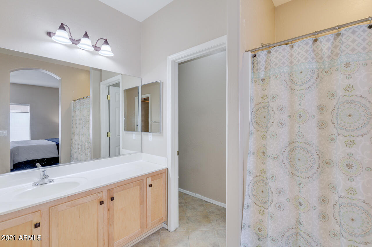44 South Greenfield Road, Unit 48 Mesa, AZ 85206 - Photo 21 of 32 a bathroom with a double vanity sink and mirror