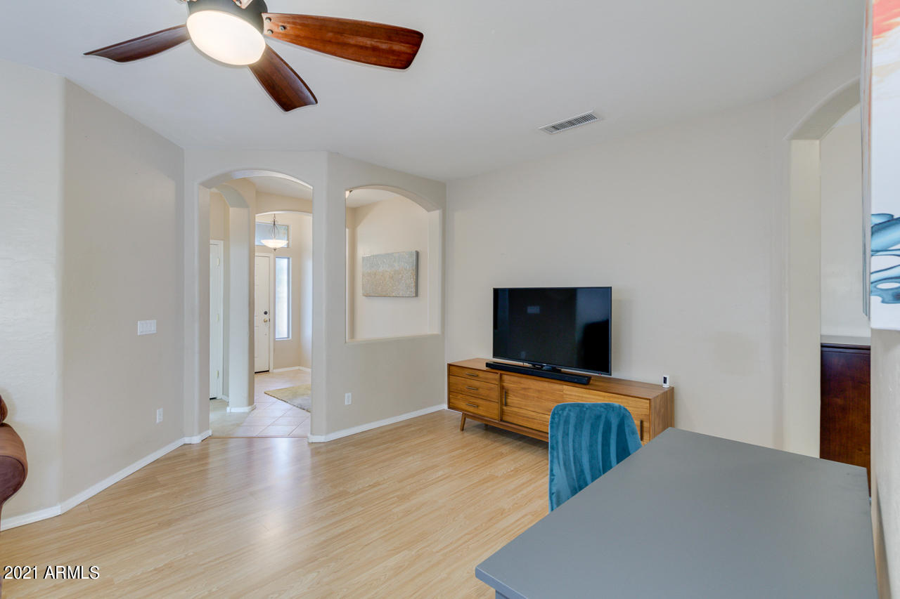 44 South Greenfield Road, Unit 48 Mesa, AZ 85206 - Photo 6 of 32 a living room with furniture and a flat screen tv