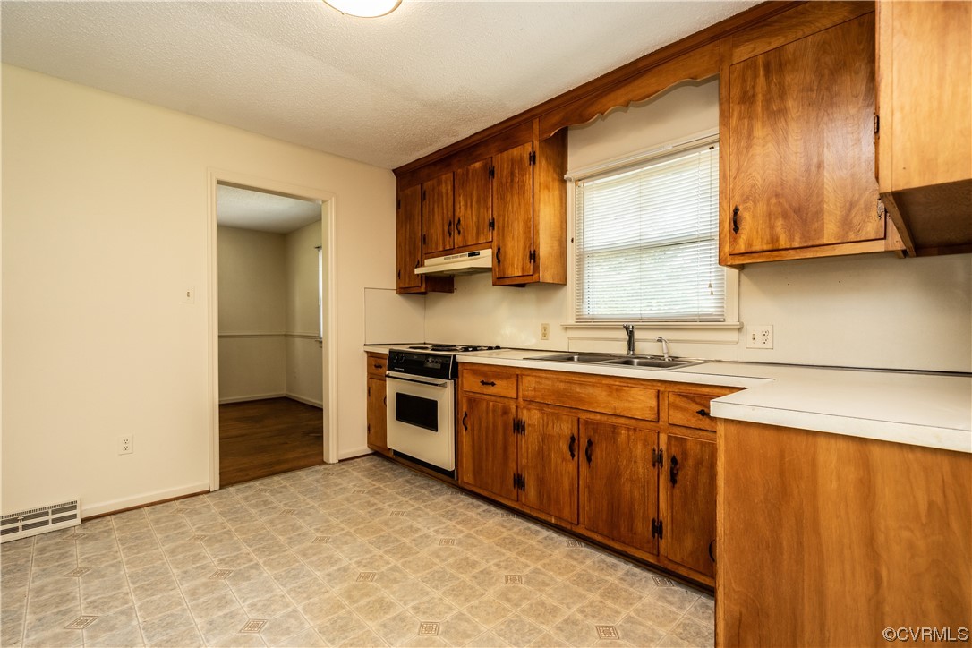 2885 Venter Road Aylett, VA 23009 - Photo 12 of 34 a kitchen with stainless steel appliances granite countertop a sink stove and refrigerator