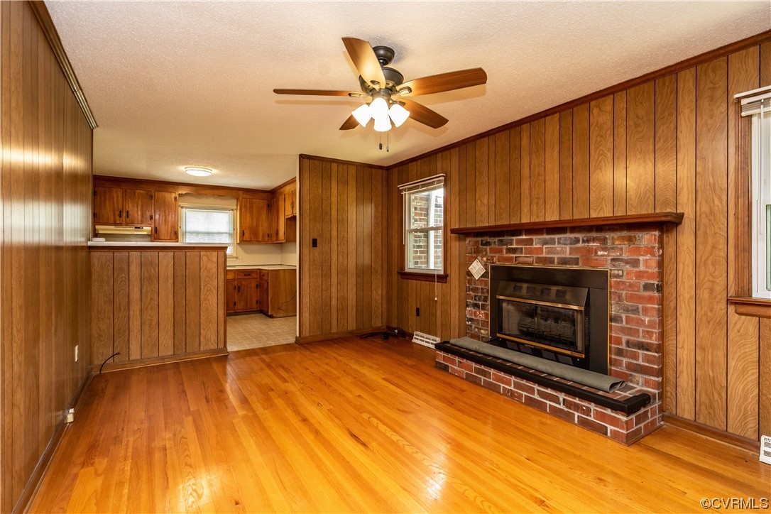 2885 Venter Road Aylett, VA 23009 - Photo 16 of 34 a view of a livingroom with a fireplace a ceiling fan and wooden floor