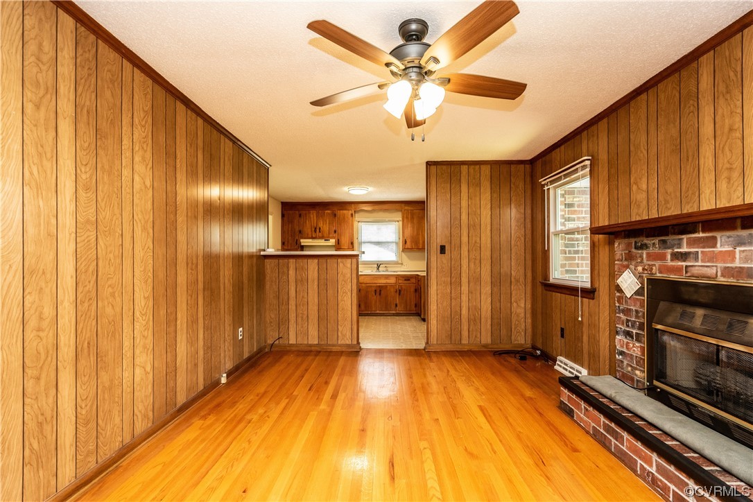 2885 Venter Road Aylett, VA 23009 - Photo 17 of 34 a view of a kitchen with a stove wooden cabinet a ceiling fan and wooden floor