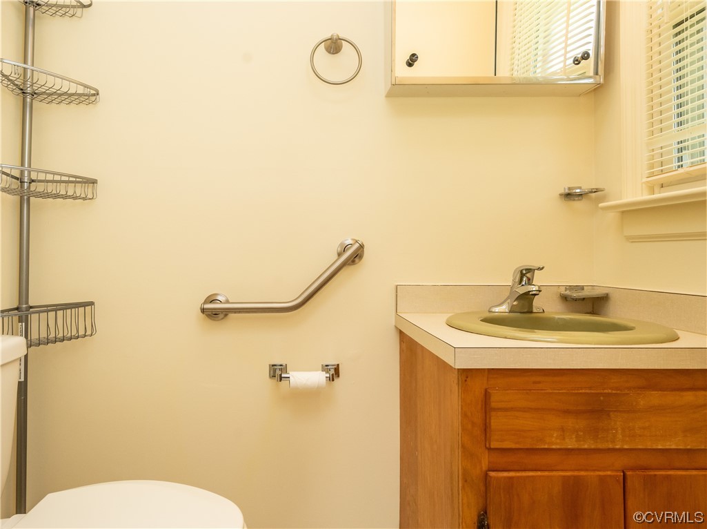 2885 Venter Road Aylett, VA 23009 - Photo 22 of 34 a bathroom with a sink and mirror with toilet
