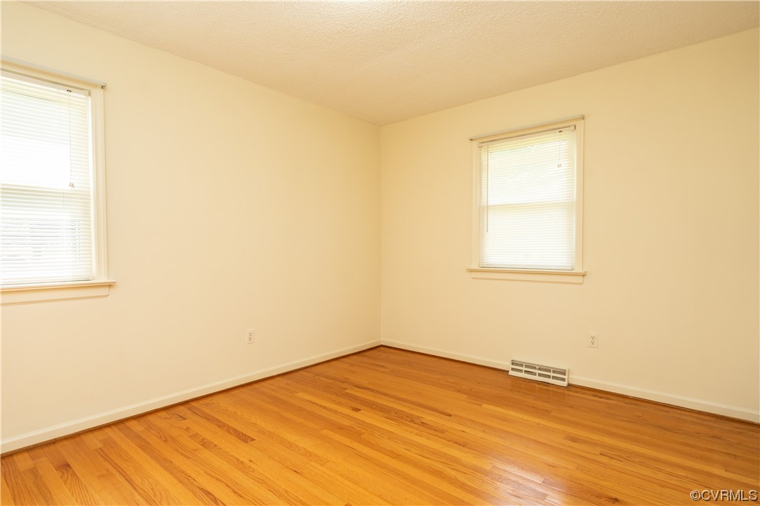 2885 Venter Road Aylett, VA 23009 - Photo 23 of 34 an empty room with wooden floor and windows