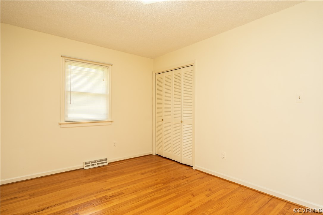 2885 Venter Road Aylett, VA 23009 - Photo 25 of 34 a view of an empty room with wooden floor and a window