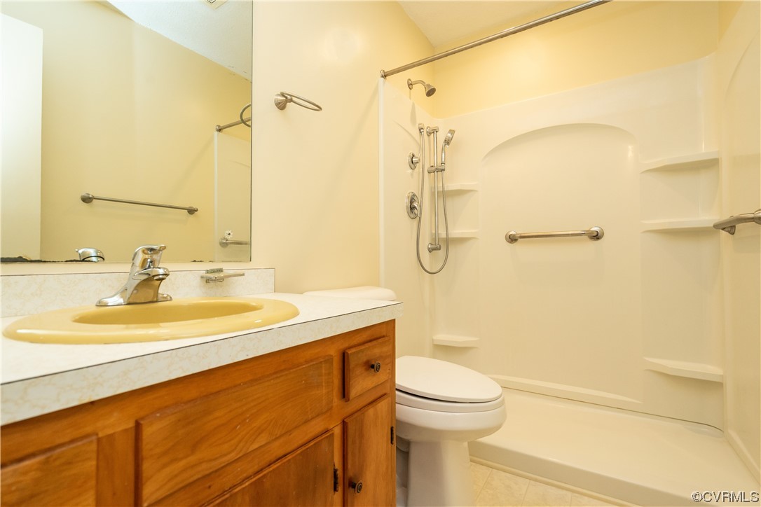 2885 Venter Road Aylett, VA 23009 - Photo 26 of 34 a bathroom with a granite countertop sink toilet and shower