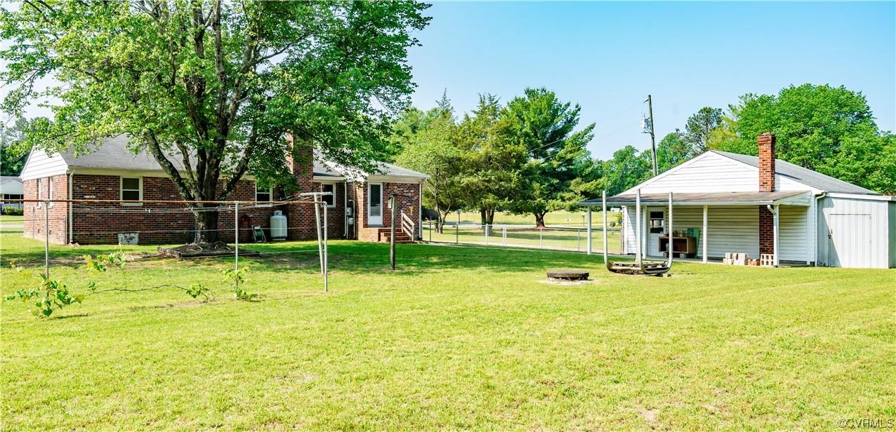 2885 Venter Road Aylett, VA 23009 - Photo 4 of 34 a backyard of a house with table and chairs