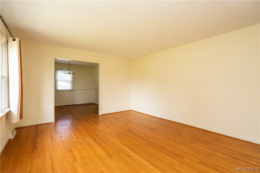 2885 Venter Road Aylett, VA 23009 - Photo 6 of 34 an empty room with wooden floor and windows