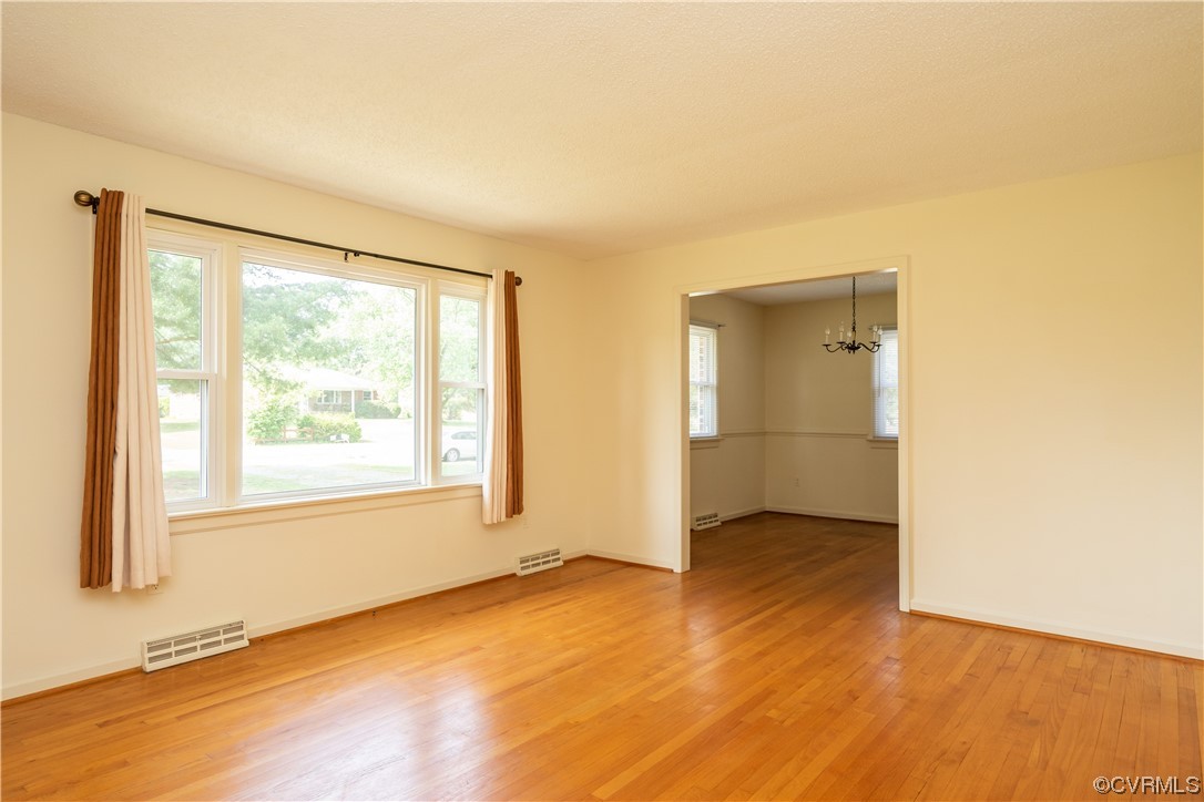 2885 Venter Road Aylett, VA 23009 - Photo 7 of 34 an empty room with wooden floor and windows