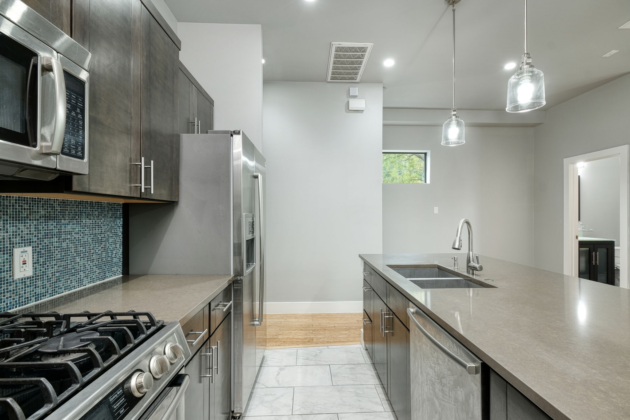 3000 Speedway Street, Unit E Austin, TX 78705 - Photo 3 of 16 Culinary delights await in this modern kitchen with stainless steel appliances and abundant counter space.
