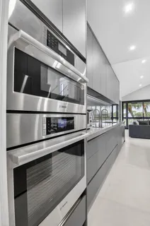 a kitchen with stainless steel appliances granite countertop a stove and a microwave