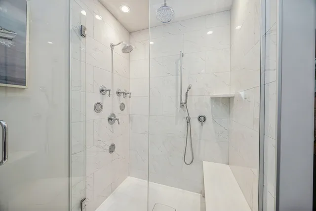 a bathroom with a shower and a glass door
