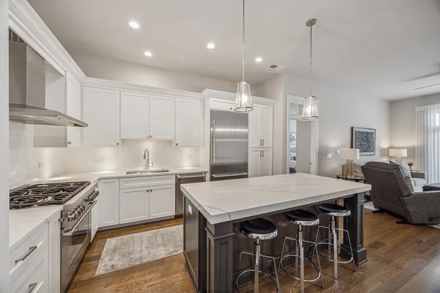 a kitchen with granite countertop a sink appliances and cabinets