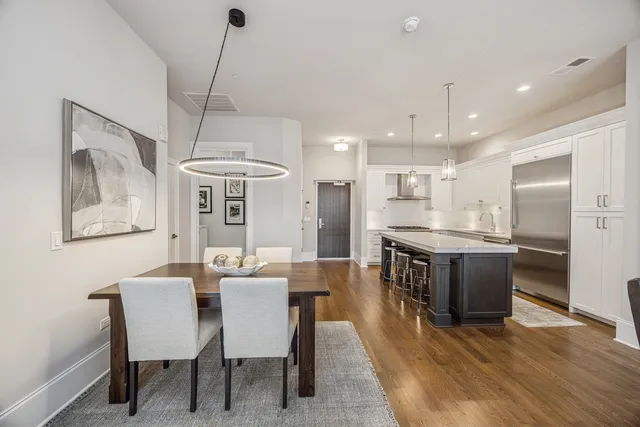 a large kitchen with a table and chairs