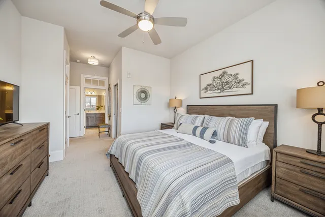 a spacious bedroom with a bed and a chandelier