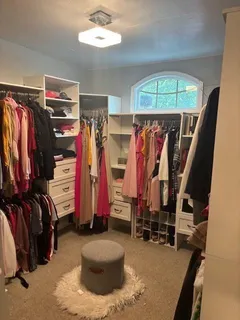 a view of walk in closet with clothes