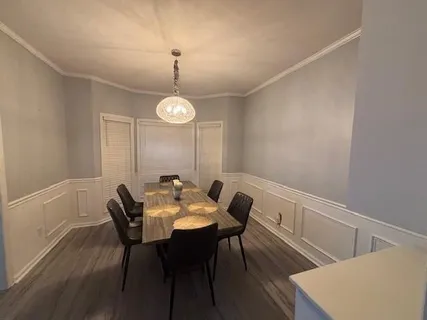 a view of a dining room with furniture and wooden floor