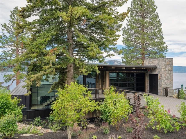 a bathroom with a double vanity sink toilet mirror and bathtub