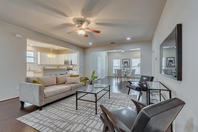 a living room with furniture and a chandelier