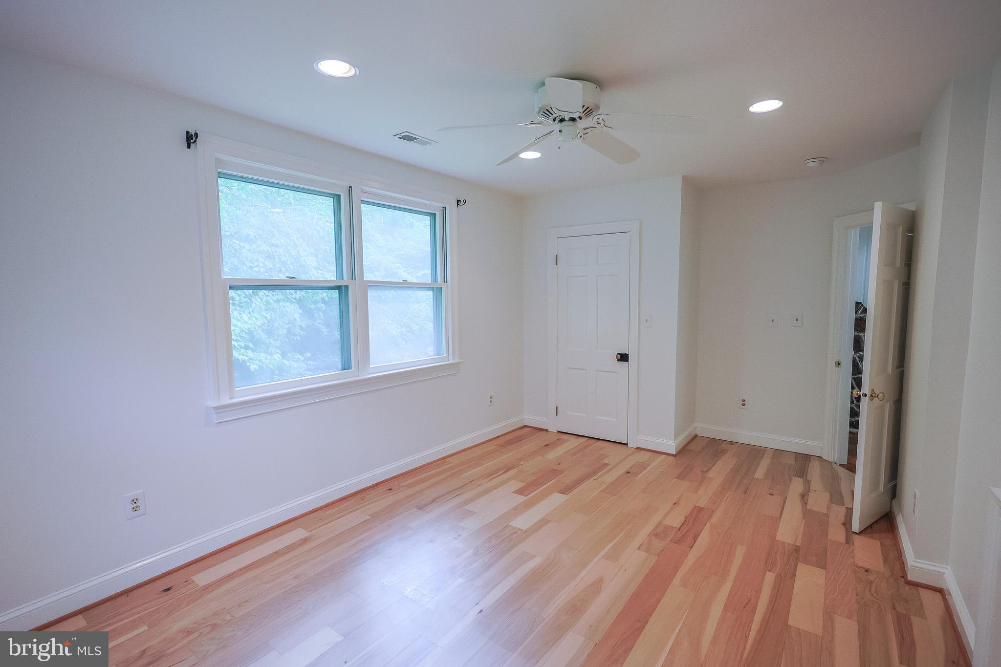 98 Swindler Hollow Road Sperryville, VA 22740 - Photo 11 of 25 a view of an empty room with wooden floor and a window