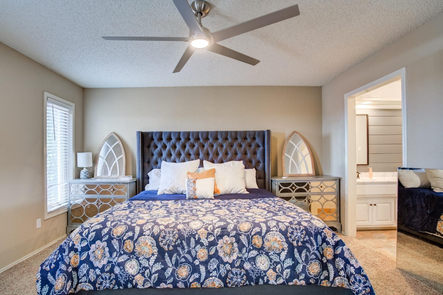 1428 5th Street Shallowater, TX 79363 - Photo 11 of 30 a bedroom with a large bed and a flat tv screen on dresser