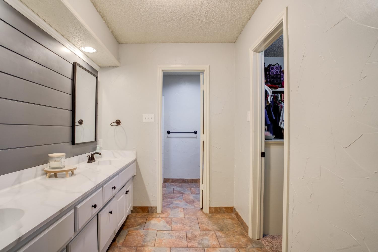 1428 5th Street Shallowater, TX 79363 - Photo 14 of 30 a bathroom with a double vanity sink and a mirror