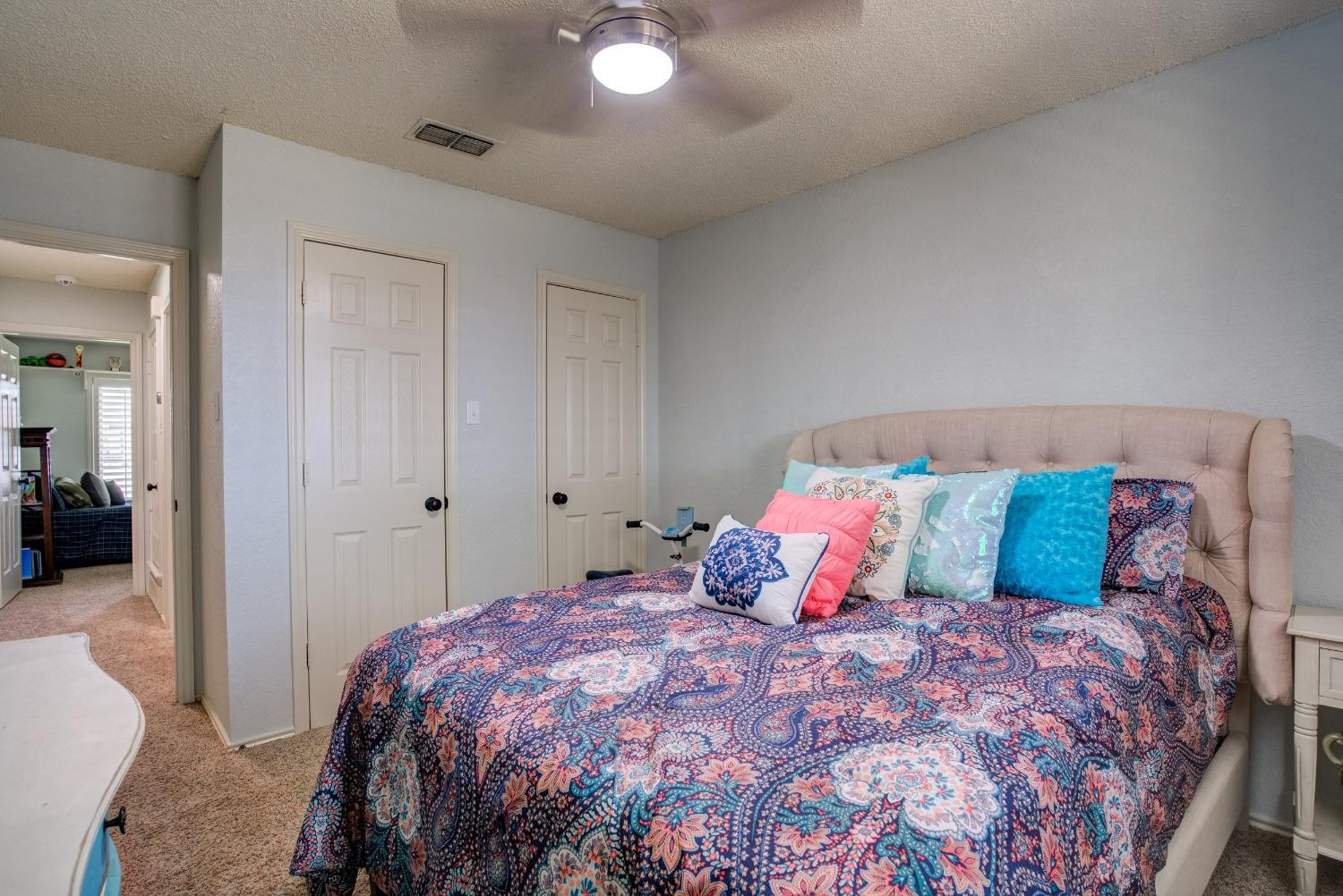 1428 5th Street Shallowater, TX 79363 - Photo 20 of 30 a bedroom with a large bed and a closet