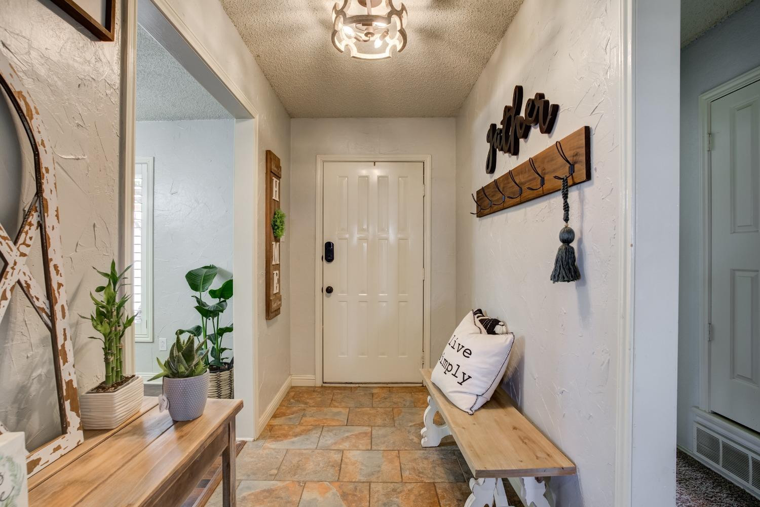 1428 5th Street Shallowater, TX 79363 - Photo 22 of 30 a room with painting on the wall and a potted plant