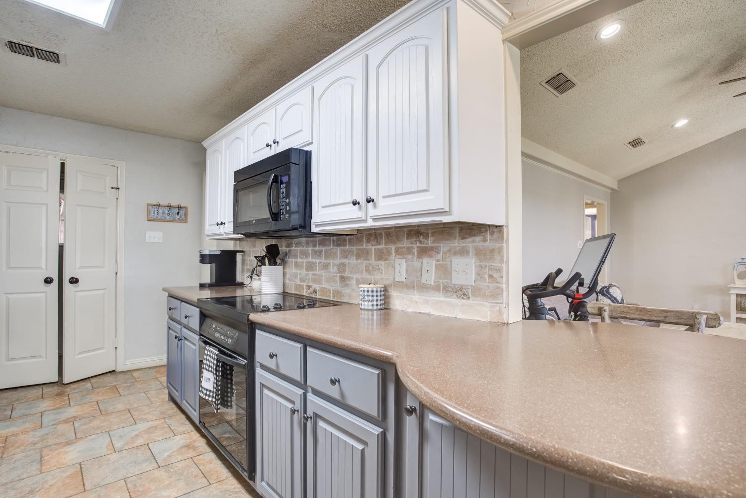 1428 5th Street Shallowater, TX 79363 - Photo 6 of 30 a kitchen with stainless steel appliances granite countertop a sink stove and cabinets