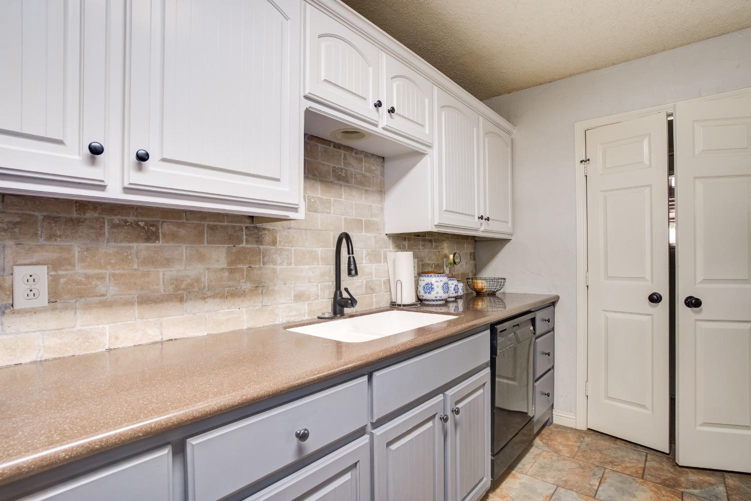 1428 5th Street Shallowater, TX 79363 - Photo 8 of 30 a kitchen with stainless steel appliances granite countertop white cabinets and a sink