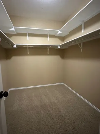 a large kitchen with a stove top oven a sink and a refrigerator